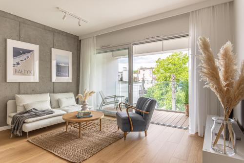 a living room with a couch and a table at S35 Apartments Gdynia Orłowo in Gdynia