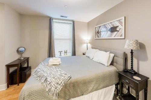a bedroom with a large bed and a window at Polk 401 in Nashville