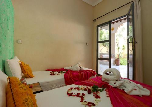 a bedroom with two beds with towel animals on them at villa saada in Marrakech