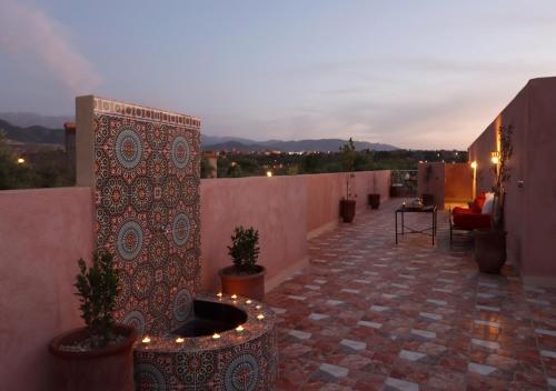 a rooftop patio with potted plants and lights at villa saada in Marrakech