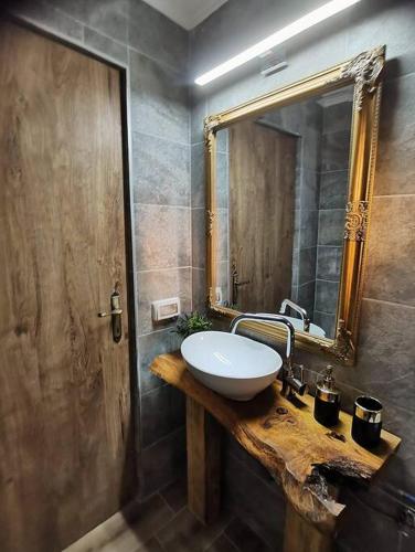 a bathroom with a sink and a mirror at Casa Her in Galaţi