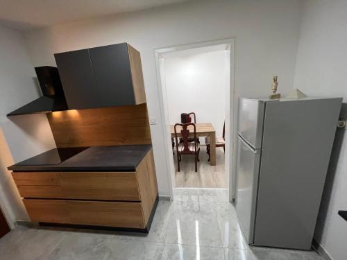 een keuken met een koelkast en een tafel met een stoel bij Sea view apartment Poreč in Poreč