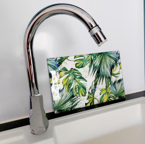 a sink with a faucet on a kitchen counter at Charmant pied-à-terre coeur de ville in Pointe-à-Pitre