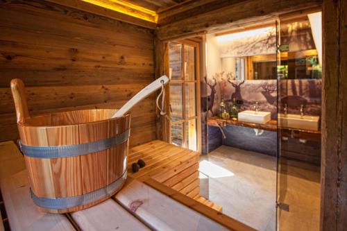 a wooden tub in a room with a bathroom at Sporer-Alm in Rohrberg