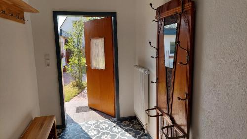 a door with a mirror next to a hallway at Ferienwohnung Am Freitagsbach in Celle