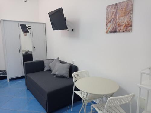 a living room with a couch and a table at Sea House Kamaraton in Marina di Camerota