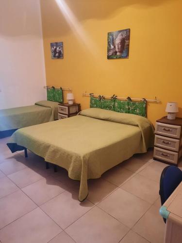 a bedroom with a bed and a yellow wall at Casa Vacanze Vista Mare in Agrigento