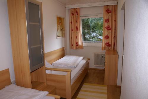 ein kleines Zimmer mit 2 Betten und einem Fenster in der Unterkunft Haus Kärnten in Bad Kleinkirchheim