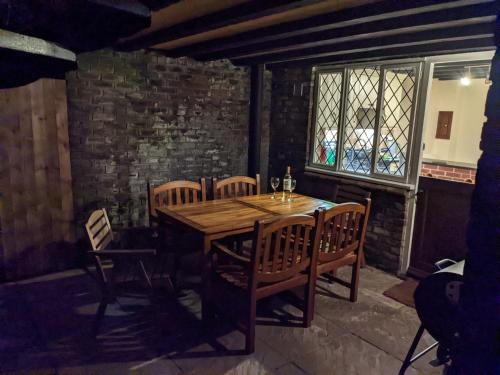 a dining room with a wooden table and chairs at Butchers Cottage in Ironbridge