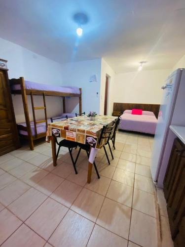 a room with a table and chairs and a bed at MI RIO in Colón