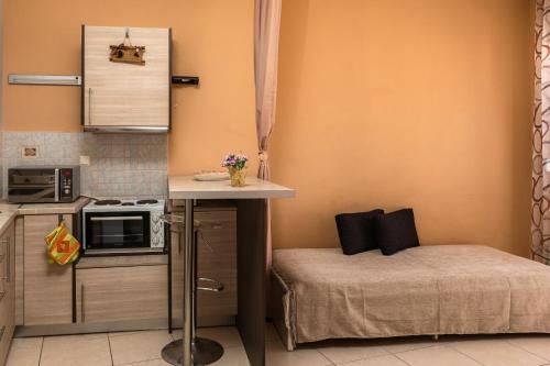 a small kitchen with a bed and a microwave at Mrs, Aphrodite's Studio in Chios