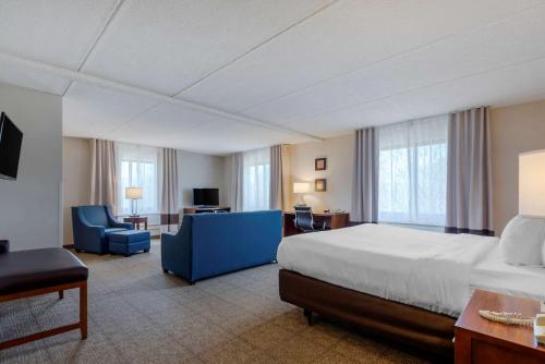 a large hotel room with a bed and a desk at Comfort Inn The Pointe in Niagara Falls