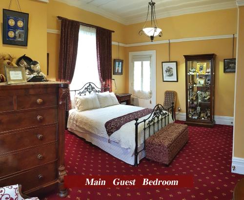 a bedroom with a bed and a dresser at The Grange in Auckland