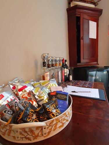 a basket filled with wine and books on a table at Foxghyll Country House in Ambleside