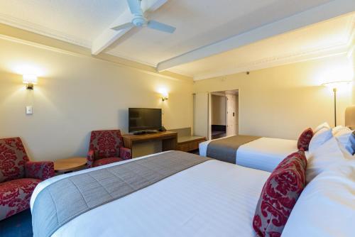 Ένα ή περισσότερα κρεβάτια σε δωμάτιο στο Distinction Hotel Rotorua