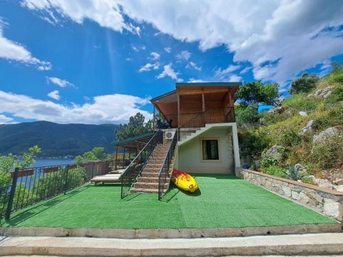 a house with a green yard with a playground at Villa Strp in Risan