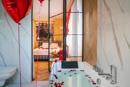a bathroom with a tub and a red balloon at GORSKI RESORT Lux Apartments Jacuzzi & Sauna in Poronin