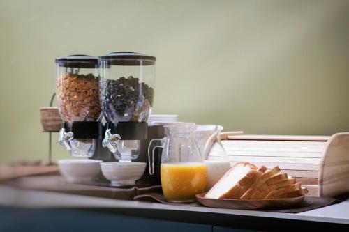 a table with a breakfast of bread and orange juice at Daon Hotel in Jeonju