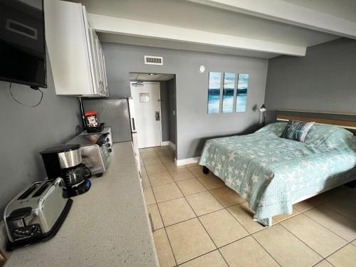 a bedroom with a bed and a tv in a room at Little Harbor #205 the place to stay in Ruskin