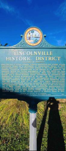 a sign for a historic district in a field at Casa Escuela in Saint Augustine