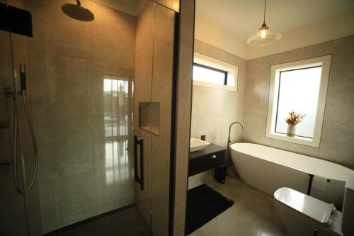a bathroom with a tub and a sink at Black Stilt Retreat, STUNNING luxury property in Twizel