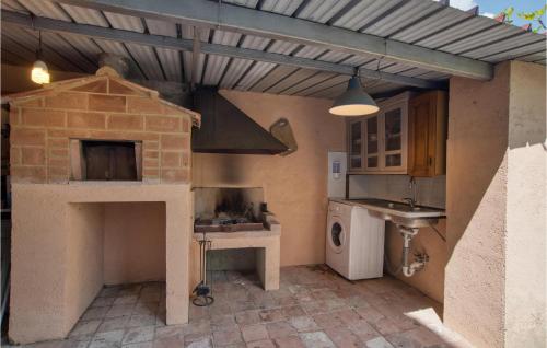 a kitchen with a brick oven and a stove at 1 Bedroom Cozy Home In Montegiovi in Montegiovi