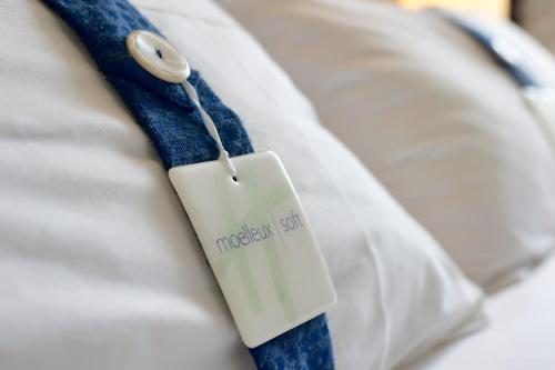 a white tag on a hospital bed at Holiday Inn Express Lille Centre by IHG in Lille