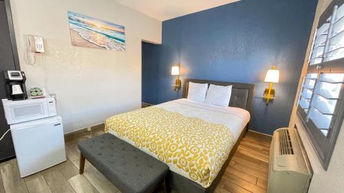 a small hotel room with a bed and a window at The Fremont Inn in Monterey