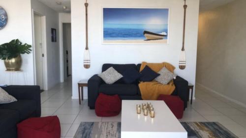 a living room with a couch and a table at #24 K I G Heights, Kings Beach - Stunning Views in Caloundra