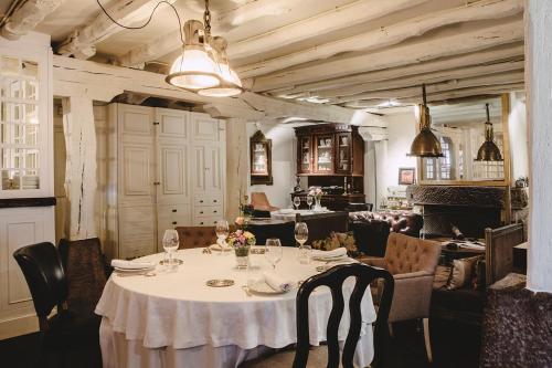 a dining room with a white table and chairs at Hotel IRARAGORRI in Galdakao