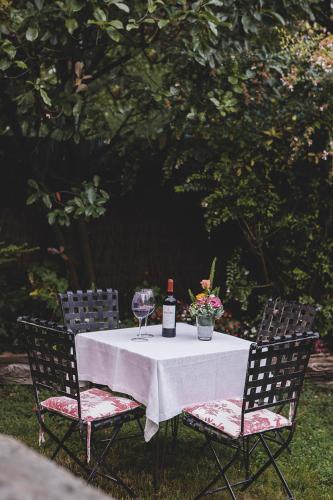 a table with a bottle of wine and a glass at Hotel IRARAGORRI in Galdakao