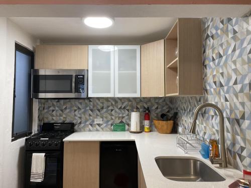A kitchen or kitchenette at Coqui del Mar - LGBTQ Hotel - Adults Only