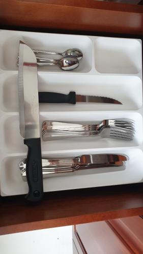 a drawer with a knife and other utensils in it at Rodrigo Building 4 in Boralesgamuwa