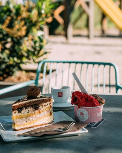 a piece of cake and a cup of strawberries on a table at Guest House Pohorska Kavarna in Maribor