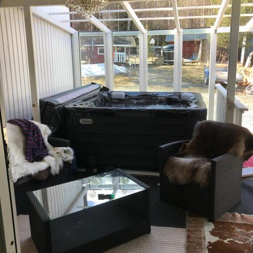 a living room with a dog sitting in a chair and a trunk at Villa Shaman in Rovaniemi