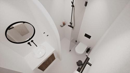 a white bathroom with a mirror and a sink at Villa Piccolo Mondo in Kalafatis