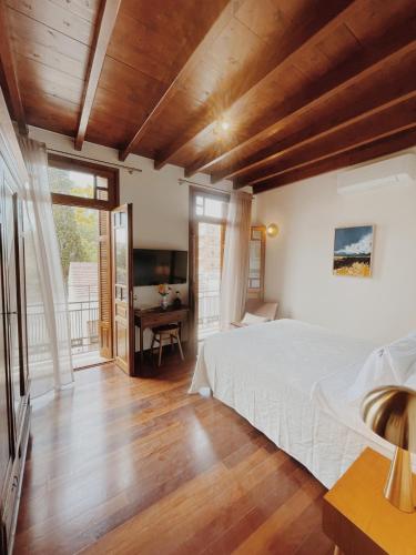 a bedroom with a bed and a desk with a television at Kale Kapi City Living in Chania