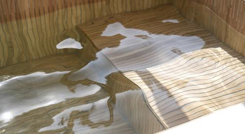 a wooden floor with a reflection of a building at Denbasta forest Hotel in Busan