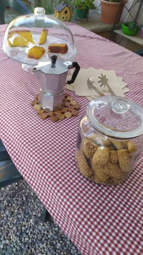 a picnic table with a table cloth with food on it at A casa di Sara in Castel San Pietro Terme