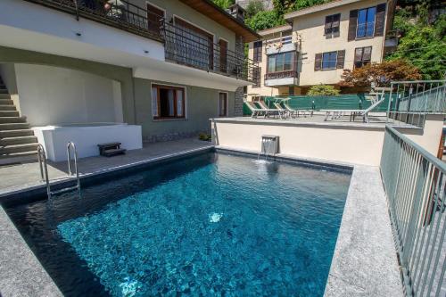 a swimming pool in front of a building at Villa Senagra Holidays Lake Como in Menaggio