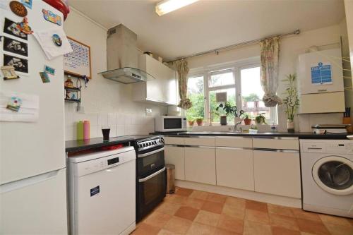 a kitchen with a sink and a stove top oven at Lovely one bed apartment to rent in London