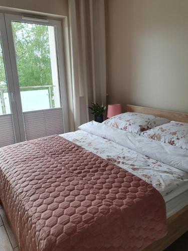 מיטה או מיטות בחדר ב-Zamiejska Modern Apartments