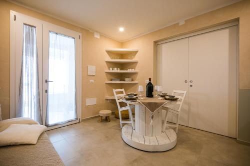 a dining room with a table and a glass door at MORF suites in Casale Marittimo