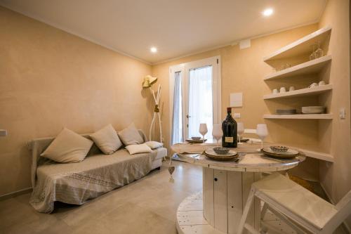 a living room with a couch and a table at MORF suites in Casale Marittimo