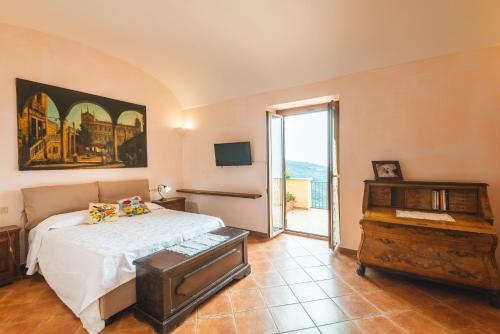 a bedroom with a bed and a dresser and a window at Casale Ianus - Country house with Panoramic View in Sorrento