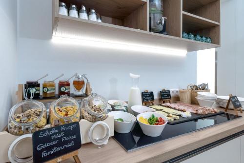 a buffet with various food items on a counter at Landhaus Bad Gleichenberg in Bad Gleichenberg