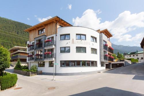 a large white building with a wooden roof at Anthony's Peaks & Pillows in Sankt Anton am Arlberg