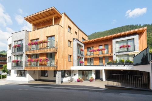 a building with flowers on the balconies of it at Anthony's Peaks & Pillows in Sankt Anton am Arlberg
