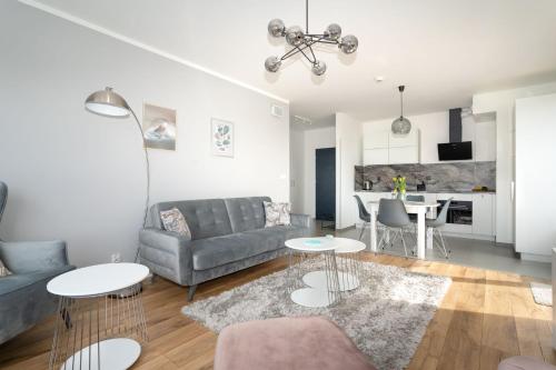 a living room with a couch and a table at Symphony Baltica Towers Apartamenty in Gdańsk