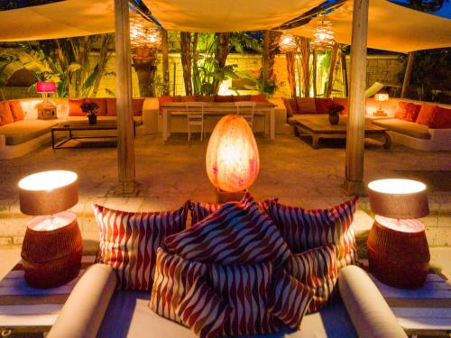 a living room with a couch and tables and chairs at La Capria Suite Hotel Alacati in Alacati